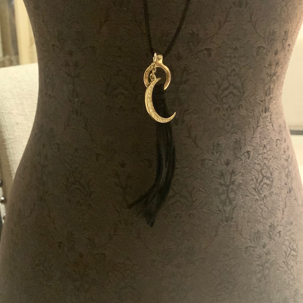 Black leather cord necklace gold tone with the rhinestones.